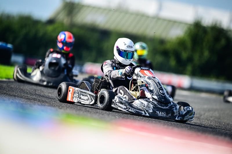 A Klaassen Motorsport TKM kart, race number 29, on track in bright sunshine.